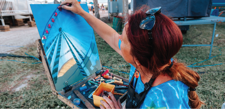 Woman painting ferris wheel