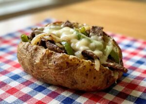 Baked Potato stuffed with Philly Steak and Cheese